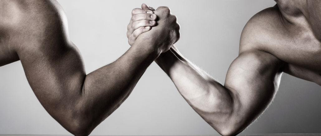 Two men arm wrestling. Rivalry, closeup of male arm wrestling. Two hands. Men measuring forces, arms. Hand wrestling, compete. Hands or arms of man. Muscular hand. Arm wrestling. Black and white.